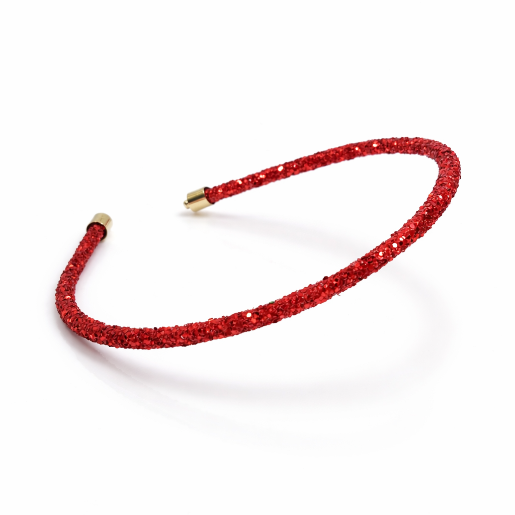 Red glittery headband with a gold clip on a white background