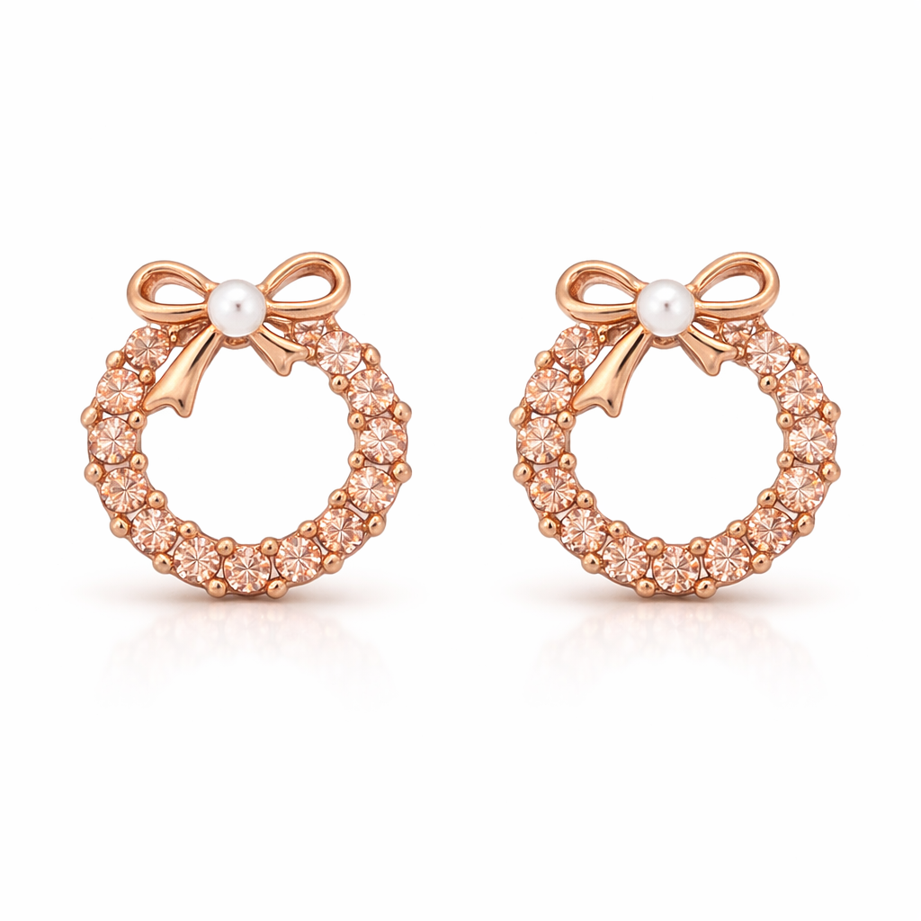 Rose gold earrings with bow and pearl center on a white background