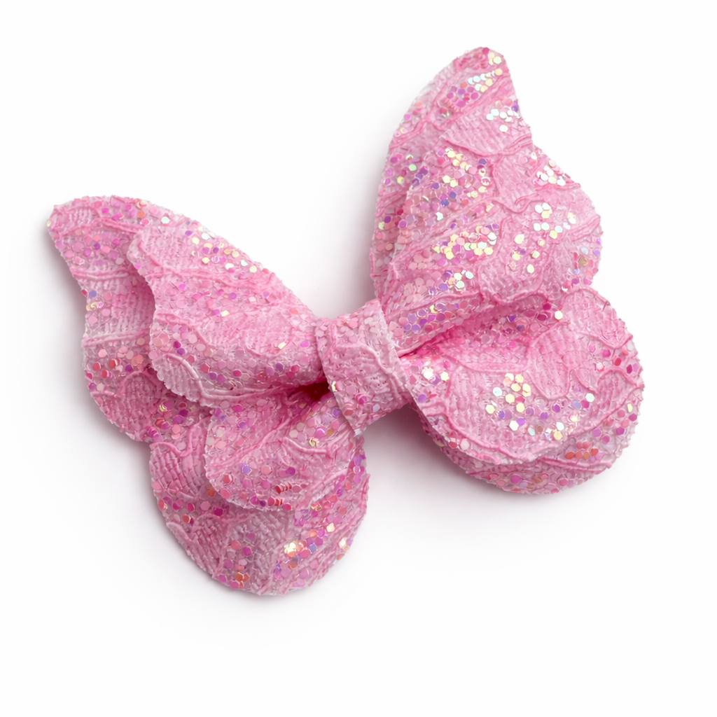 Pink glittery bow on a white background