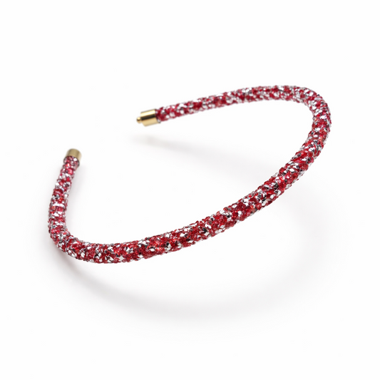 Red headband with gold accents on a white background