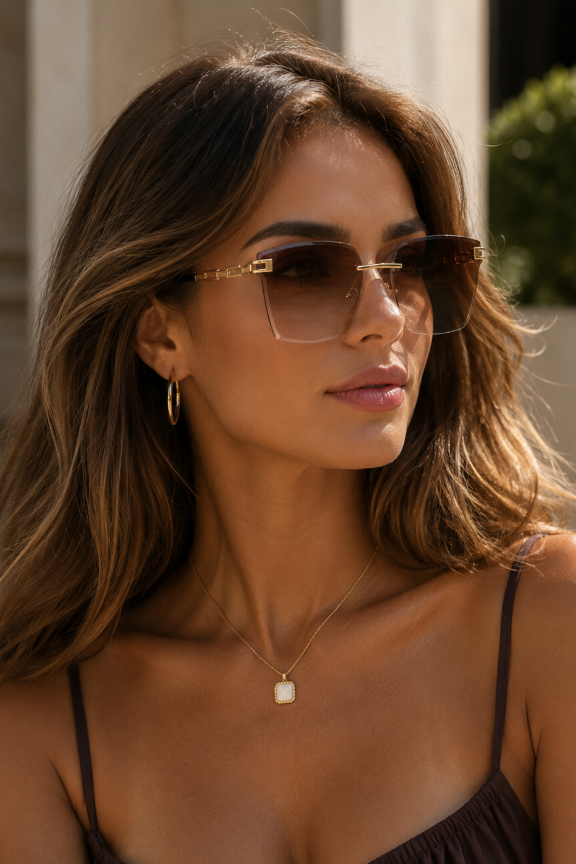Woman wearing sunglasses with a neutral background