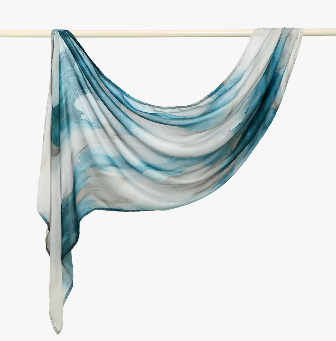 Blue and white scarf draped over a rod on a white background